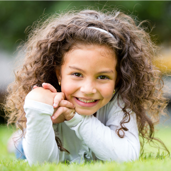 Young Girl Laying in Grass