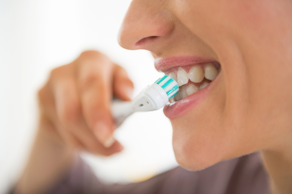 close up of woman brushing teeth