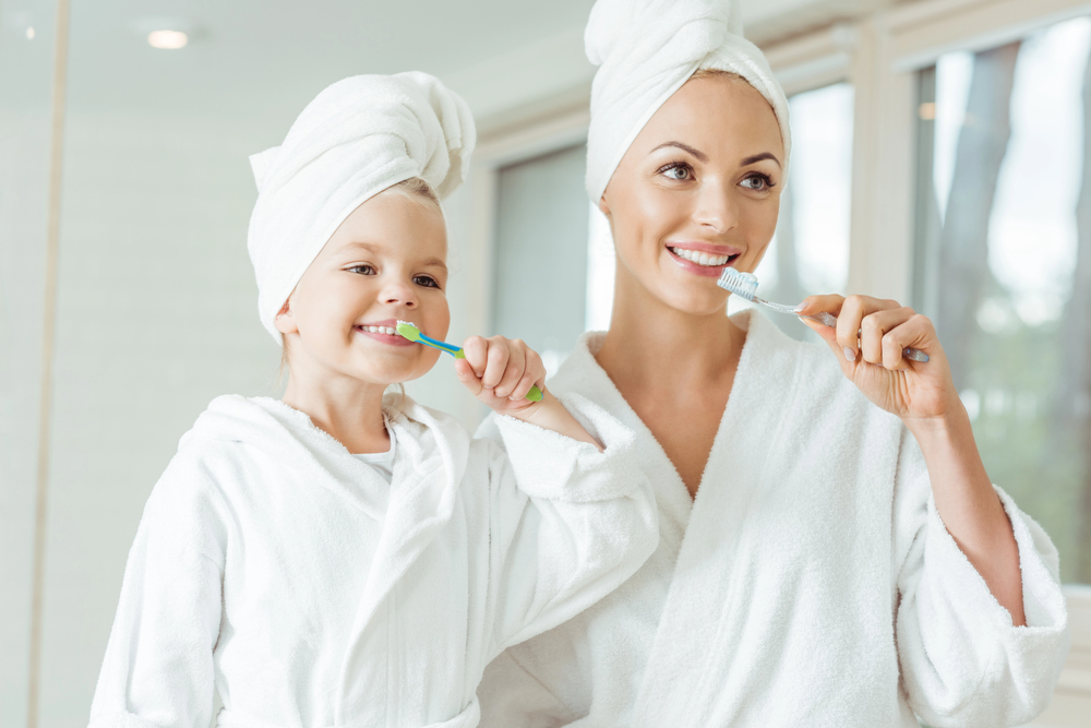 mom and daughter practicing daily oral hygiene